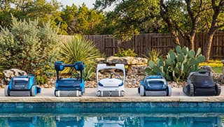 Robotic pool cleaner climbing the wall and scrubbing the waterline of an inground pool